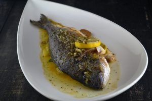 Whole Roasted Sea Bream with Stone Potatoes, Green Tomato, Mustard Greens, Smoked Corn Pure at 1700 Degrees Steakhouse in Harrisburg PA